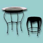 Wrought iron table with glass and chair combination.